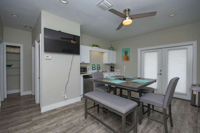 Bright, open dining area with modern kitchen and cozy seating