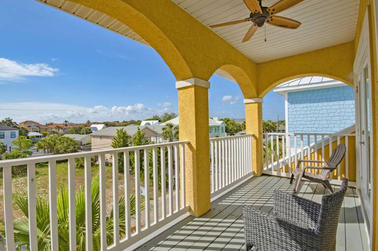 Sunlit balcony with panoramic views and cozy seating