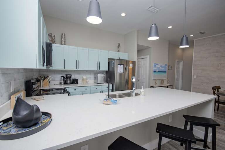 Sleek modern kitchen with spacious island and stainless steel appliances