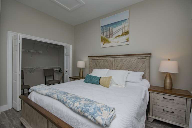 Cozy bedroom retreat with serene coastal artwork and soft lighting
