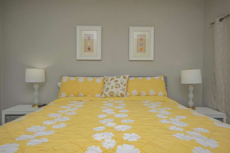 Cozy bedroom retreat with cheerful yellow bedding and soft lighting