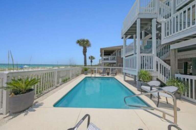 Poolside Picture Perfect With Palms, Pristine Blue, And Boardwalk Beckoning