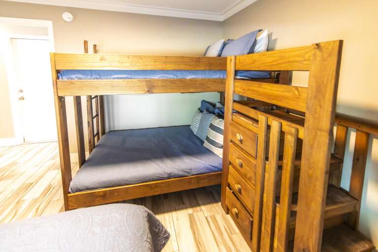 Cozy bunk bedroom with warm wood accents and natural light
