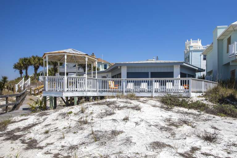Oceanfront deck with panoramic beach views and cozy seating
