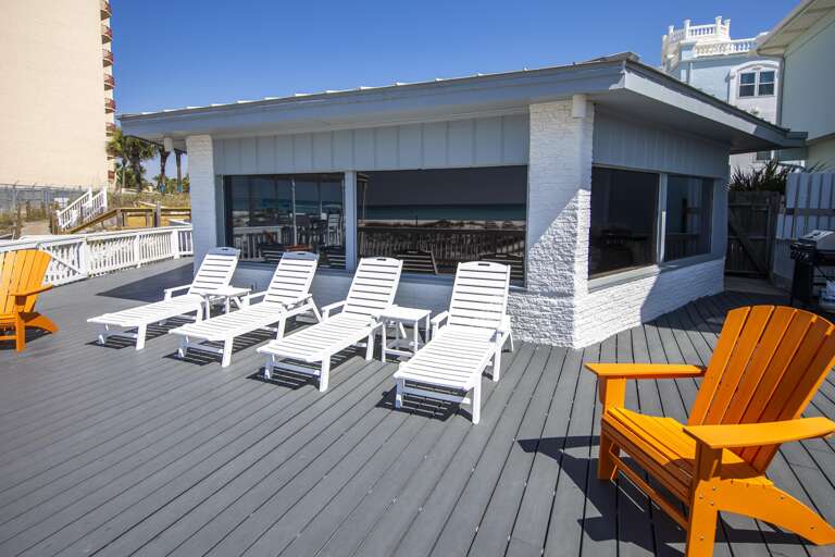 Spacious sun deck with loungers and cozy seating area