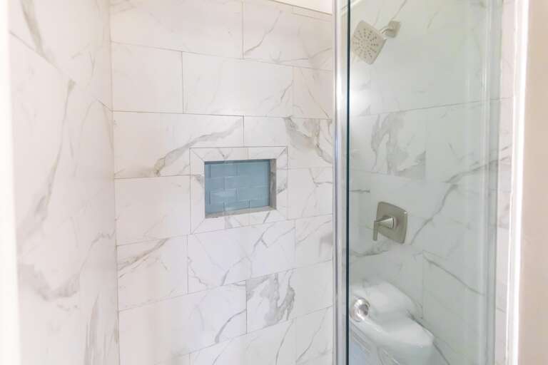 Spa-like shower with sleek marble tile and modern fixtures
