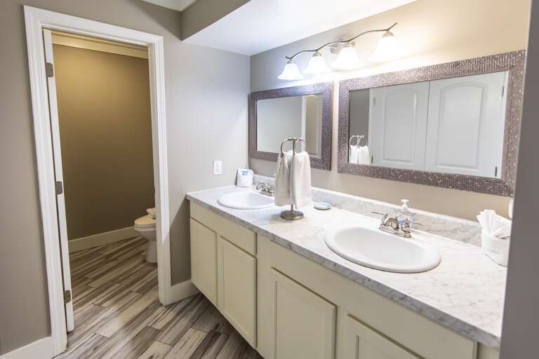 Bright, spacious bathroom with modern double vanity and ample storage