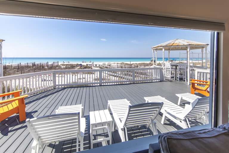 Spacious oceanfront deck with panoramic beach views