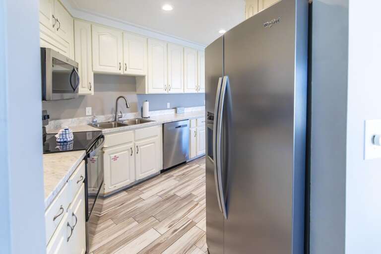 Bright, modern kitchen with stainless steel appliances and ample storage