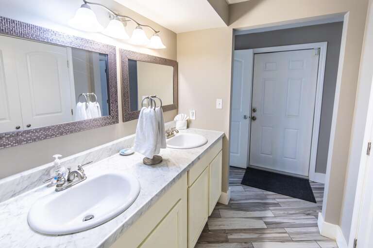 Bright, spacious bathroom with dual sinks and modern finishes
