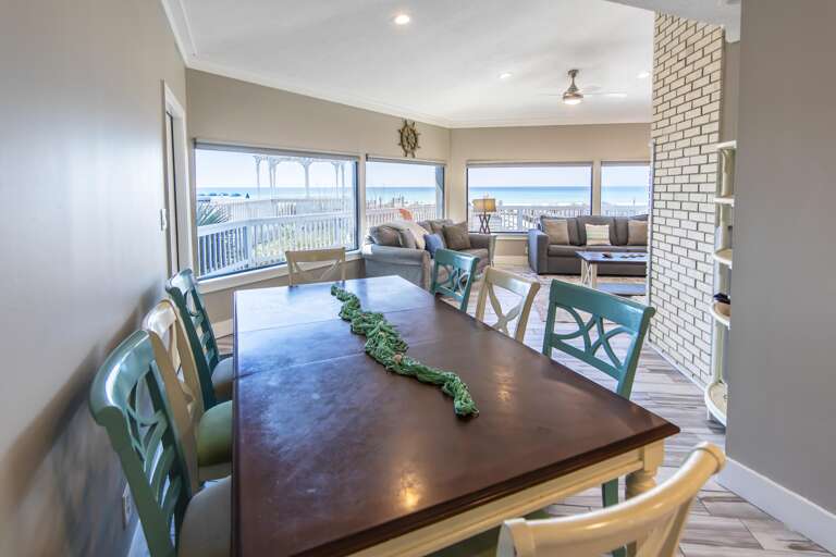 Sunlit dining area with panoramic waterfront views