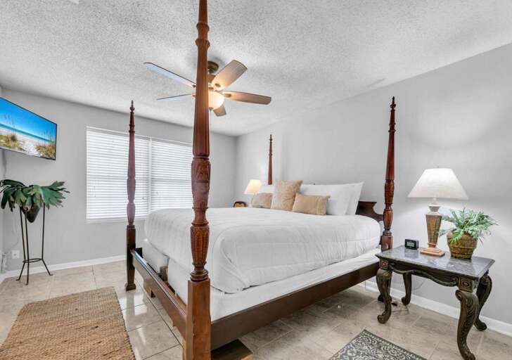 Bright and airy bedroom with elegant four-poster bed