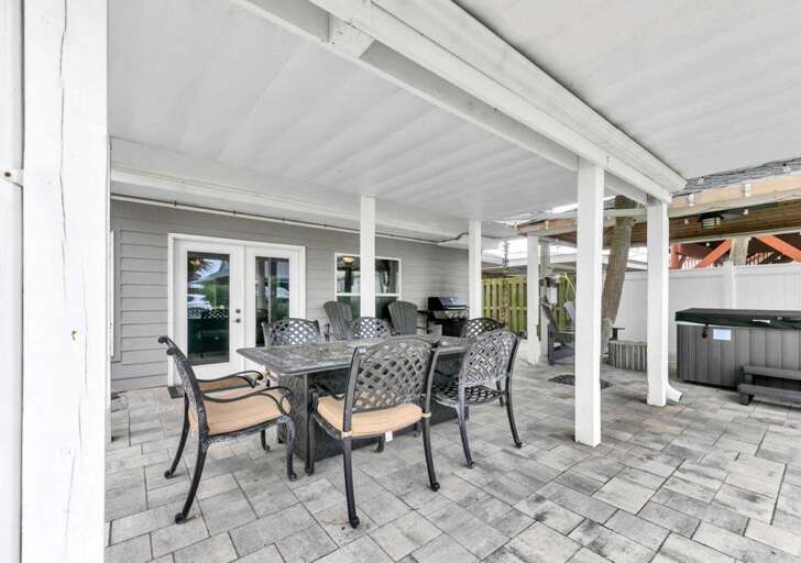 Spacious covered patio with dining and lounge seating for gatherings