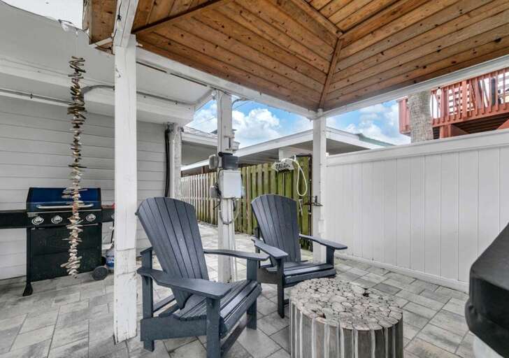 Cozy outdoor patio with fire pit and grill for gatherings