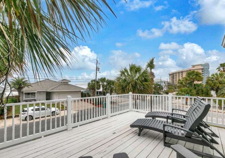 Spacious sun-drenched deck with relaxing lounge chairs
