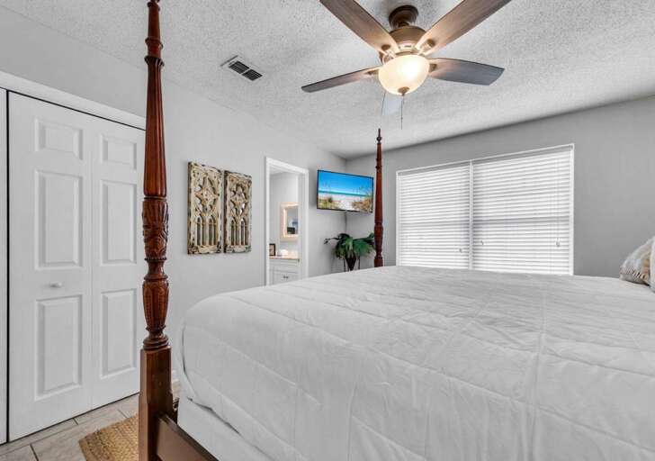 Bright and airy bedroom with cozy four-poster bed