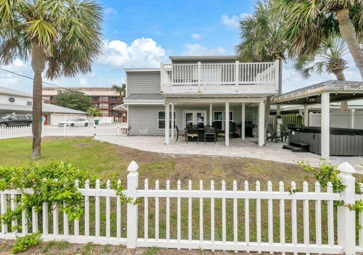 Spacious outdoor patio with covered seating and tropical vibes Spacious outdoor patio with covered seating and tropical vibes