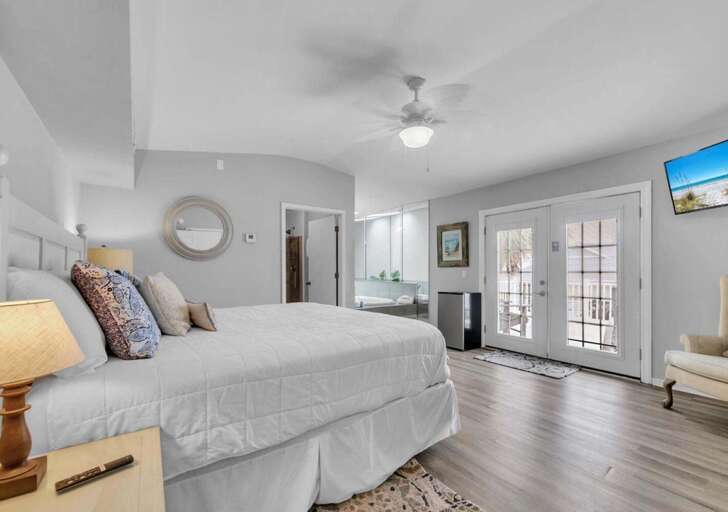 Spacious bedroom with private balcony and serene views