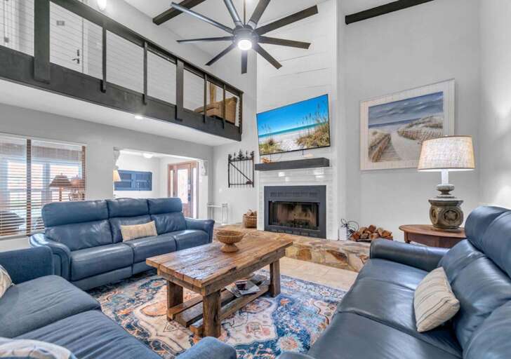 Spacious living room with vaulted ceilings and cozy fireplace