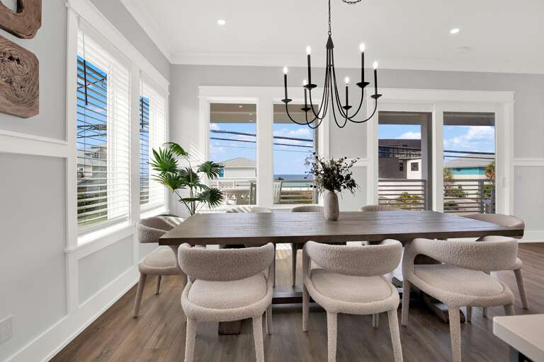 Sunlit dining room with serene water views and elegant charm