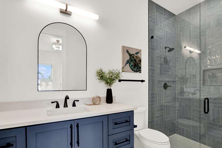 Modern bathroom retreat with sleek glass shower and navy vanity