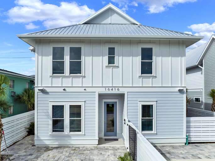 Charming two-story home with bright, airy facade and private entry.