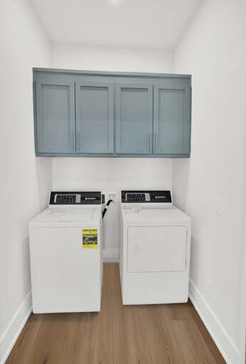 Bright laundry room with modern washer and dryer units