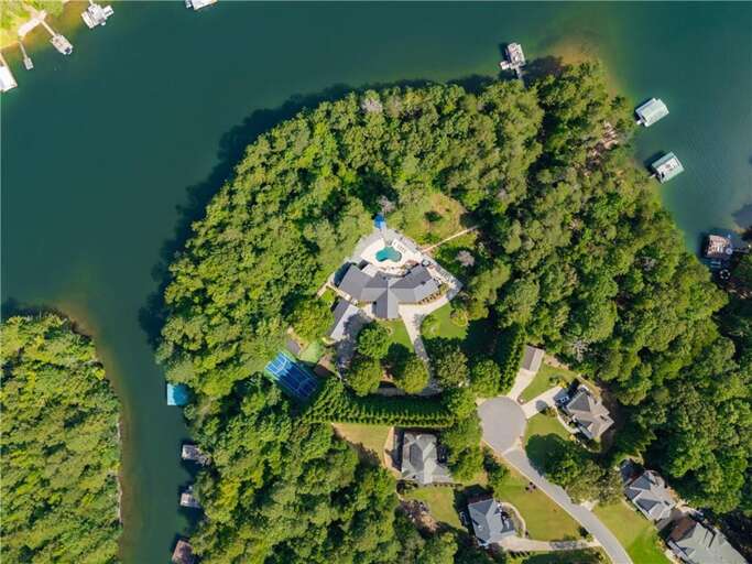 Secluded waterfront estate with private dock and lush greenery