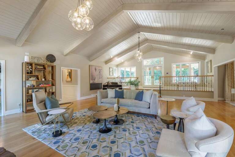 Spacious living room with vaulted ceilings and elegant chandelier