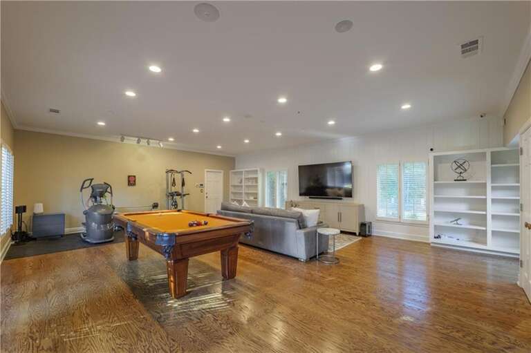 Spacious game room with pool table and cozy seating area