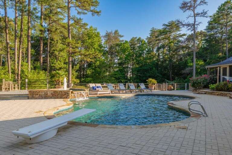 Tranquil outdoor pool area surrounded by lush pine trees