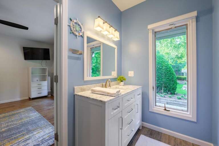 Bright bathroom with garden views and modern vanity
