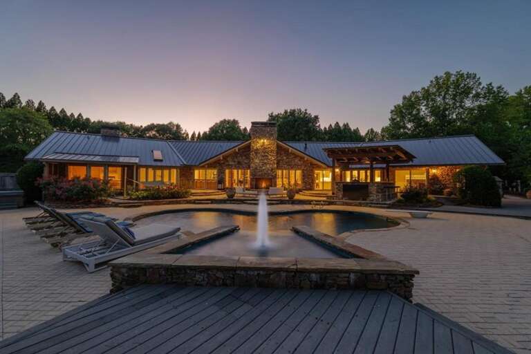 Sprawling outdoor patio with tranquil fountain and sunset views Sprawling outdoor patio with tranquil fountain and sunset views