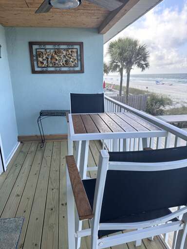 Oceanfront balcony with cozy seating and stunning views