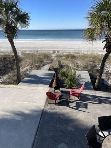Oceanfront patio with cozy seating and stunning beach views