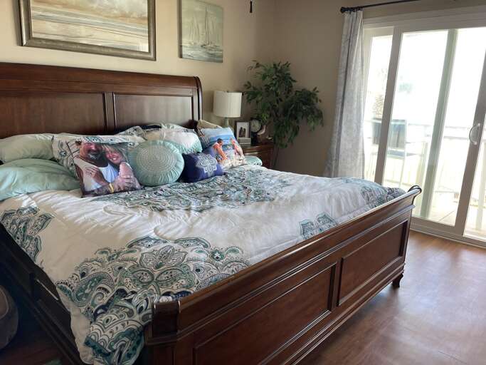 Spacious bedroom with cozy bedding and natural light Spacious bedroom with cozy bedding and natural light