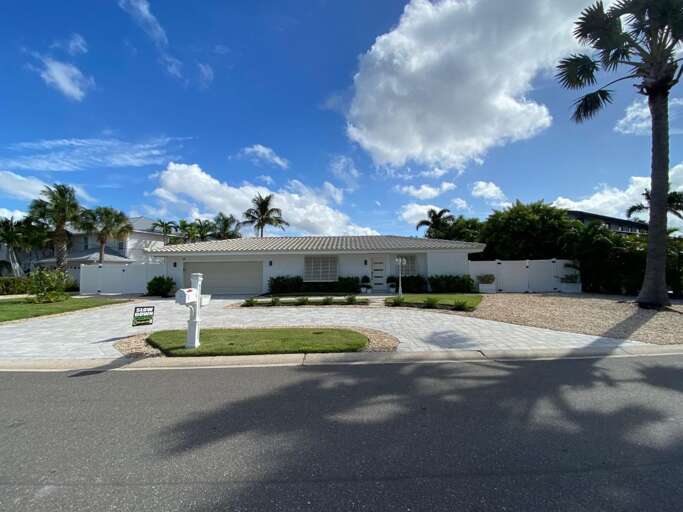 Single-story Residence Under Sunny Skies, Surrounded By Swaying Palms