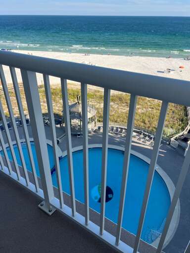 View of pool and beach from balcony
