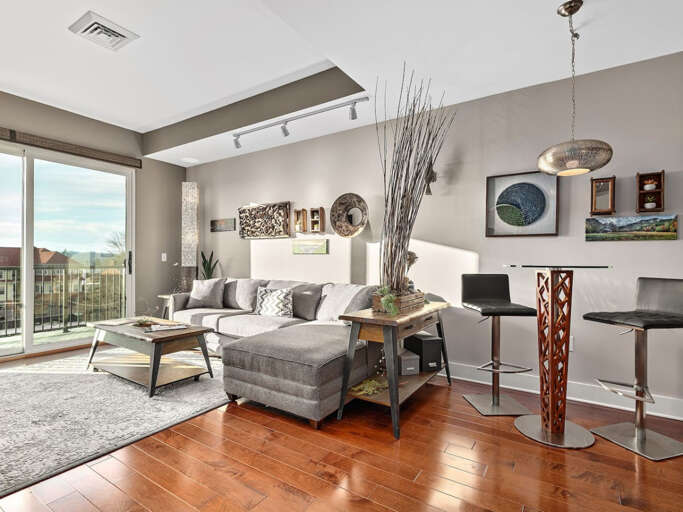 Bright open living/dining area. Bistro table for 2 or 4 can sit around kitchen island. Bright open living/dining area. Bistro table for 2 or 4 can sit around kitchen island.