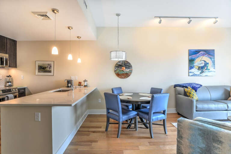 Brightly-lit Living Space With Dining Area And Kitchen, Sleek Surfaces, Serene Seating