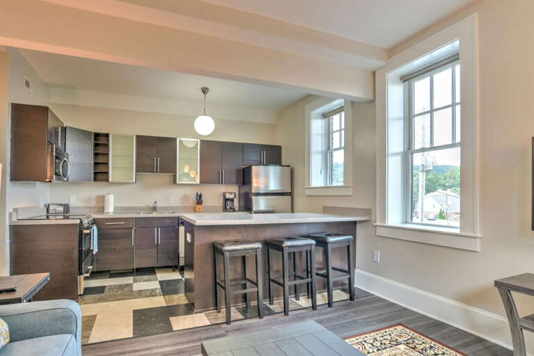 Bright, Breezy Vacation Rental Kitchen With Bar Seating And Broad Windows
