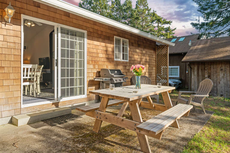 Quaint backyard with picnic table, chairs and BBQ Quaint backyard with picnic table, chairs and BBQ