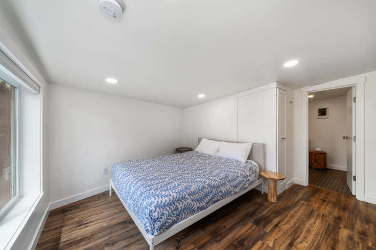 Upstairs queen bed with low ceiling and attached bathroom with walk in shower Upstairs queen bed with low ceiling and attached bathroom with walk in shower