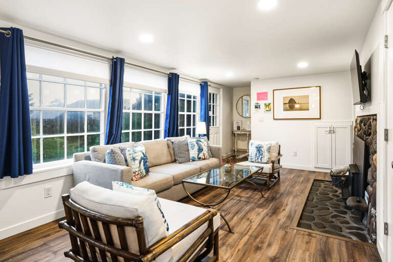 Living area open to the dining room. With smart tv and woodstove. 