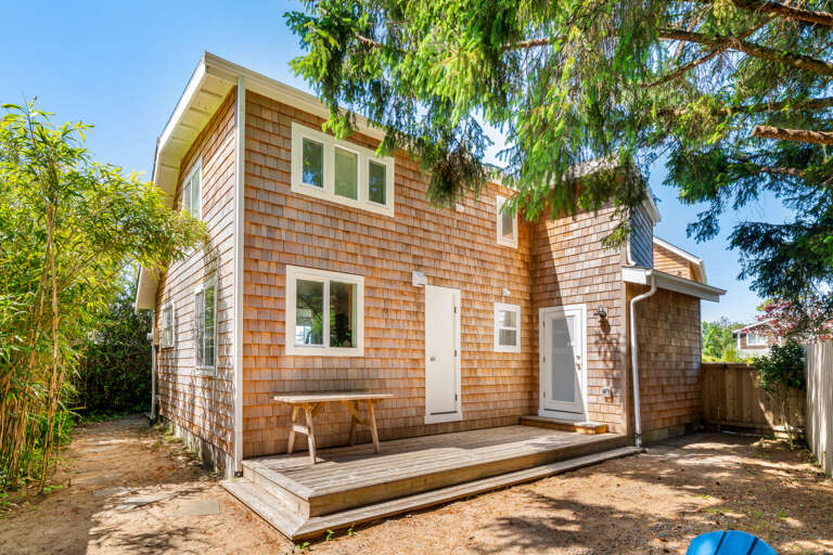 Backyard area with solo stove firepit and picnic table.