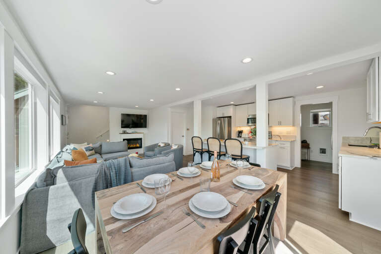 Dining room open to Living room with electric fireplace, Streaming TV, and kitchen with Bar seating. 