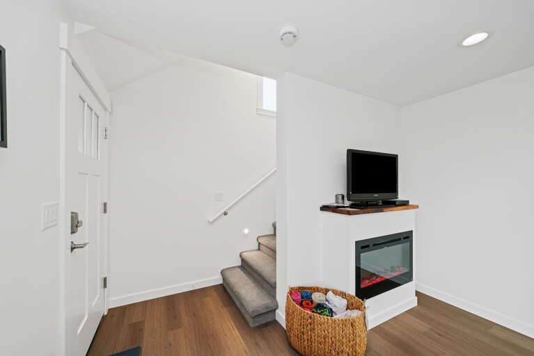 Stairs to upper floor

Living room with Cable and Streaming TV, Electric fireplace open to dining and new remodeled Kitchen with all new appliances. 