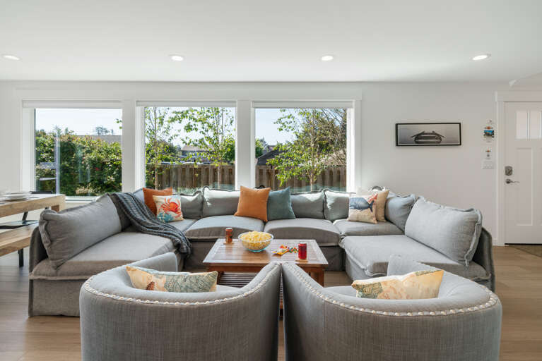 Living room with electric fireplace, Streaming TV, open to dining room and kitchen with Bar seating. 