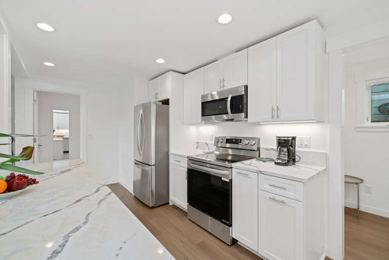 Newly remodeled Kitchen with all new appliances, breakfast bar with 2 stools, Open to kitchen and dining area. With Pass through Window to outdoor living space. 