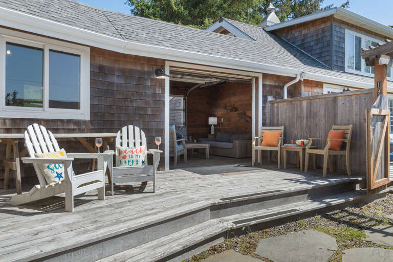 Outdoor living space with covered lounging furniture, streaming TV, dining area, open to back yard with BBQ. With uncovered sun deck for lounging Outdoor living space with covered lounging furniture, streaming TV, dining area, open to back yard with BBQ. With uncovered sun deck for lounging